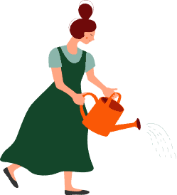 Woman watering a landscaped garden with hardscape features.